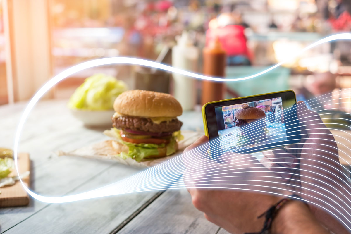 Customer posting social media using restaurant free wifi