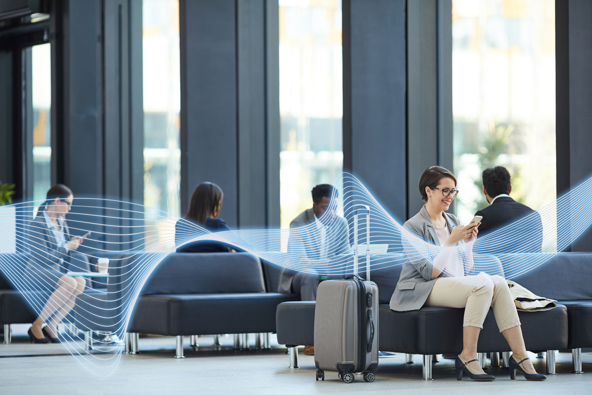 Passenger using WiFi network in airport departure lounge