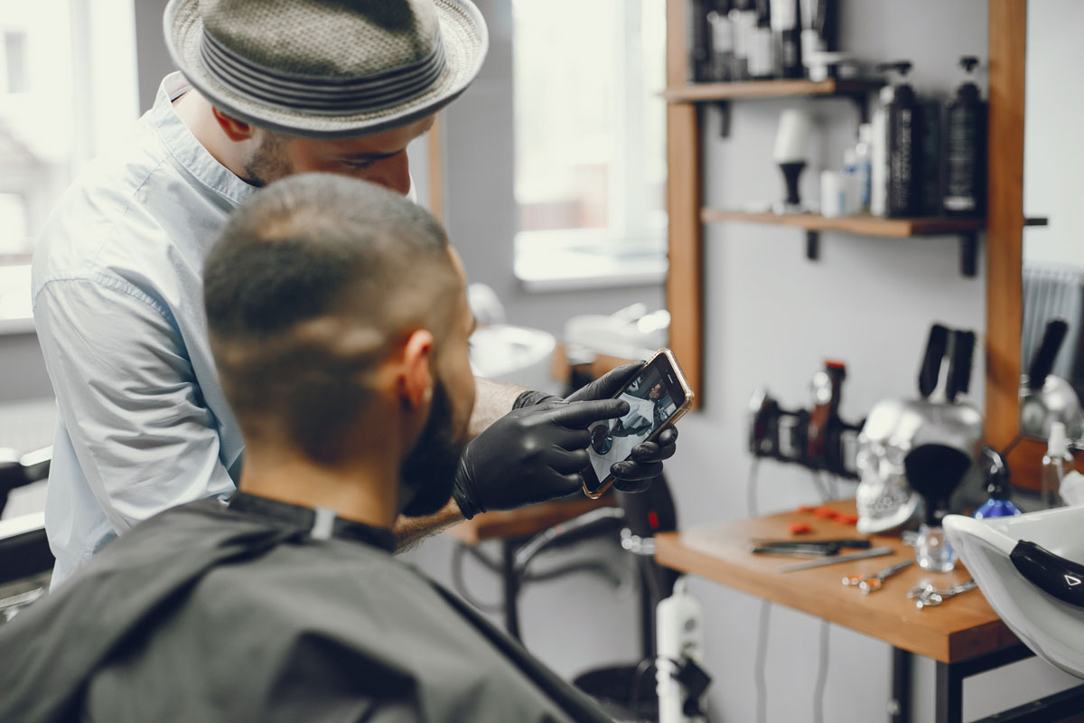 Barber using WiFi to show customer haircut style