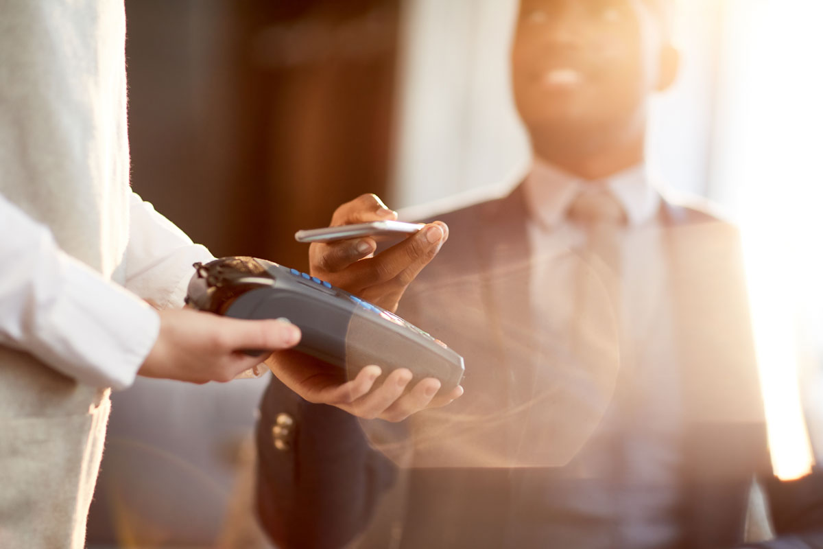 Customer using contactless payment in restaurant