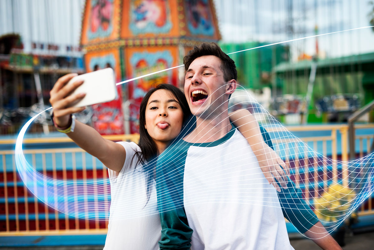 Young Couple Using Theme Park WiFi Network