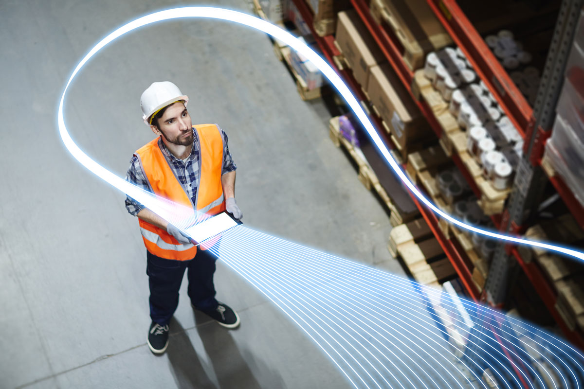 Warehouse worker using WiFi network for stock take